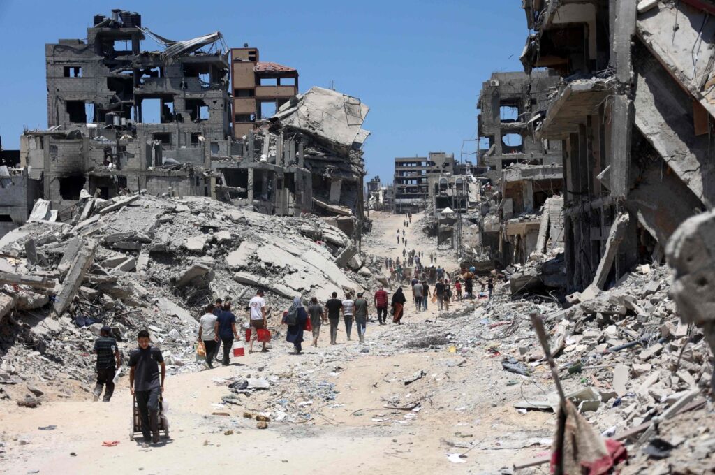 Palestinians walk through the rubble of destroyed buildings after the Israeli military withdrew following a two-week assault on the Shujaiya neighborhood, east of Gaza City, Palestine, July 11, 2024. (AFP Photo)