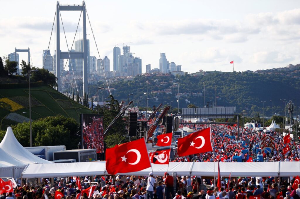 People wave Türkiye's national flags as they arrive to attend a ceremony marking the first anniversary of the July 15 coup attempt at the Bosphorus Bridge in Istanbul, Türkiye, July 15, 2017. (Reuters Photo)