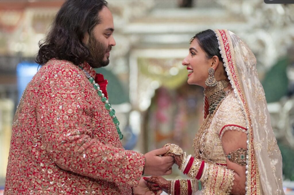 Anant Ambani (L), the son of billionaire Mukesh Ambani, holds hands with Radhika Merchant during their wedding ceremony in Mumbai, India, July 12, 2024. (AP Photo)