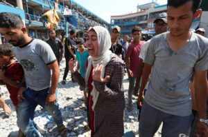 A Palestinian woman reacts at the site of an Israeli airstrike on a U.N. school sheltering displaced people, Nusairat, Gaza Strip, Palestine, July 14, 2024. (Reuters Photo)