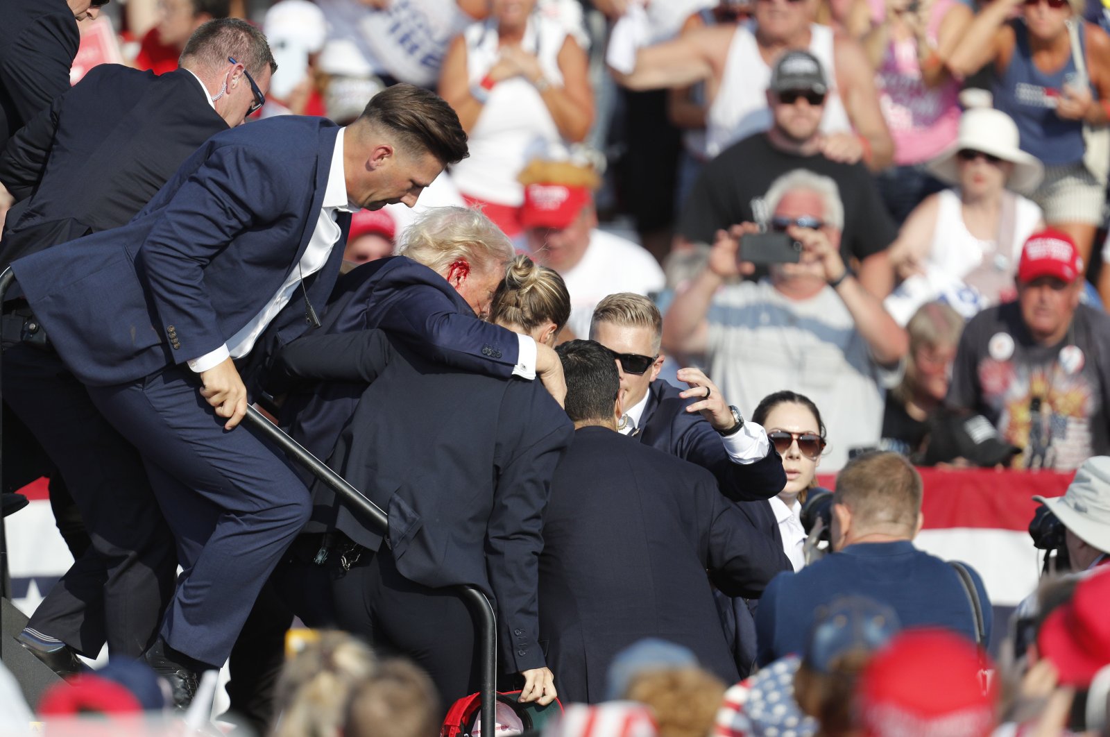 Former U.S. President Donald Trump is rushed from the stage by the Secret Service after being shot at during a campaign rally at the Butler Farm Show Inc. in Butler, Pennsylvania, U.S., July 13, 2024. (EPA Photo)