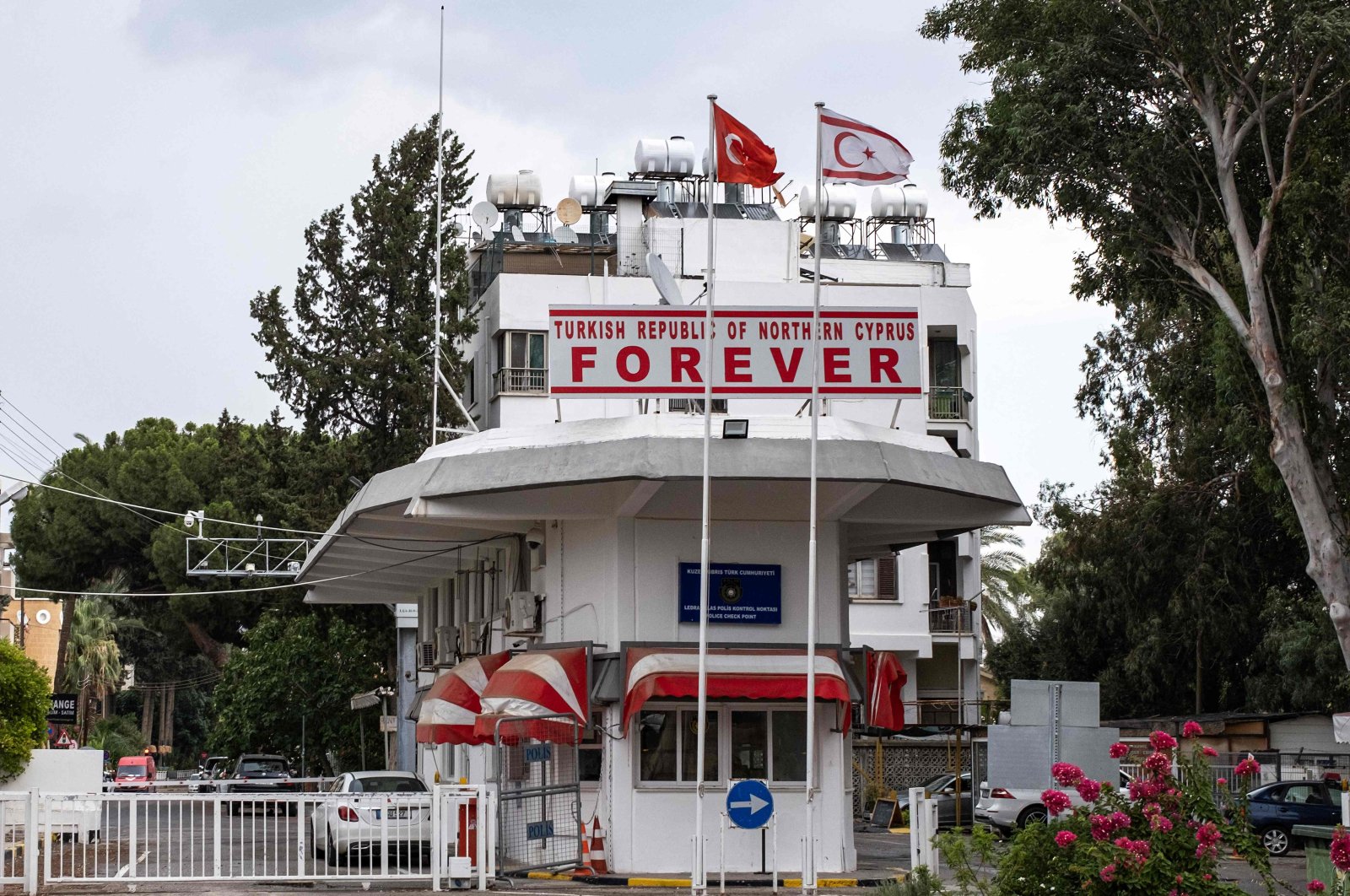 The flags of Türkiye and the Turkish Republic of Northern Cyprus (TRNC) fly above a checkpoint leading to a buffer zone, Lefkoşa (Nicosia), TRNC, July 11, 2024. (AFP Photo)