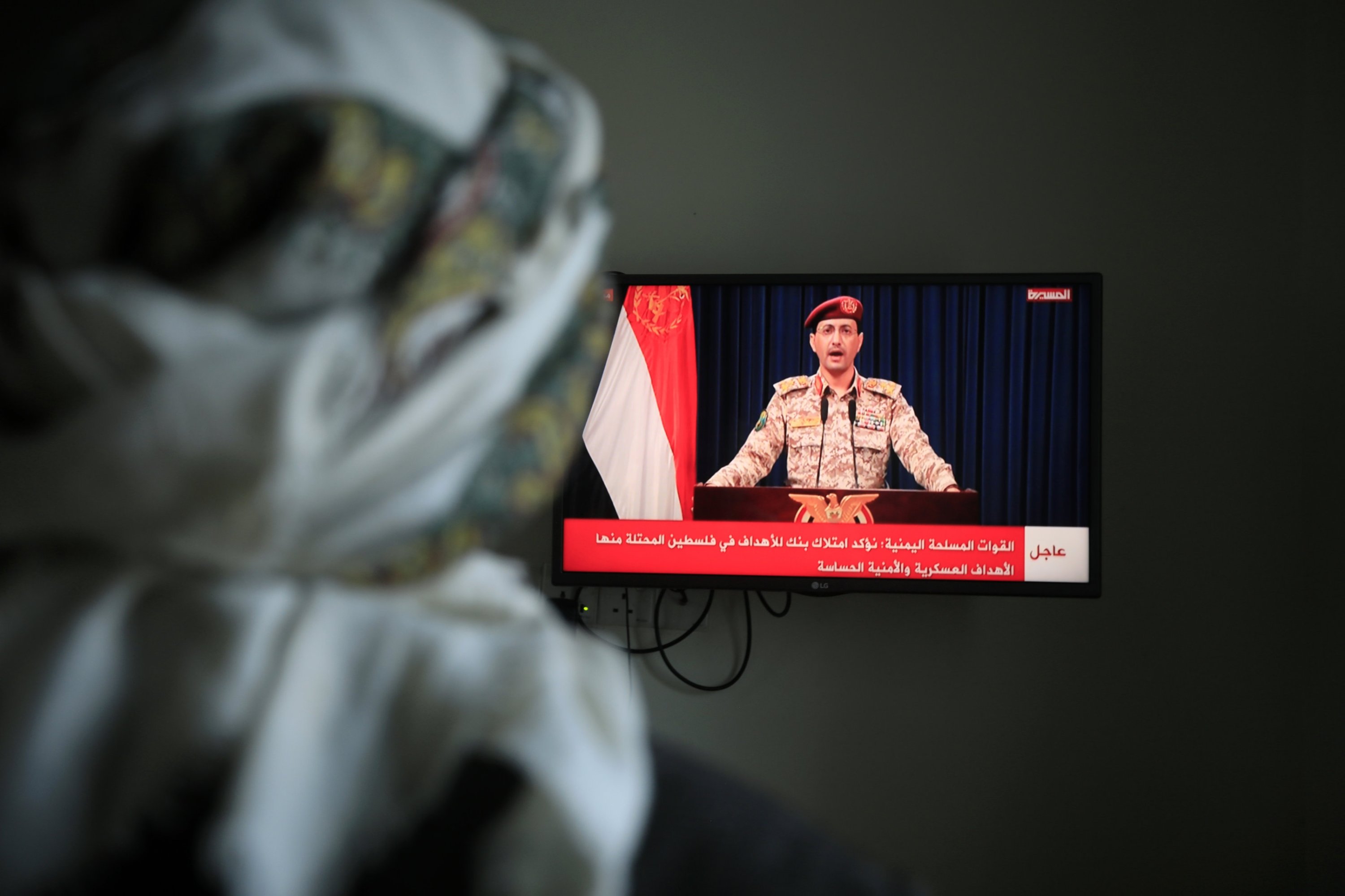 337581 A person watches Houthi military spokesperson Yahya Sare'e delivering a televised statement about an attack on Tel Aviv, Sanaa, Yemen, July 19, 2024. (EPA Photo)
