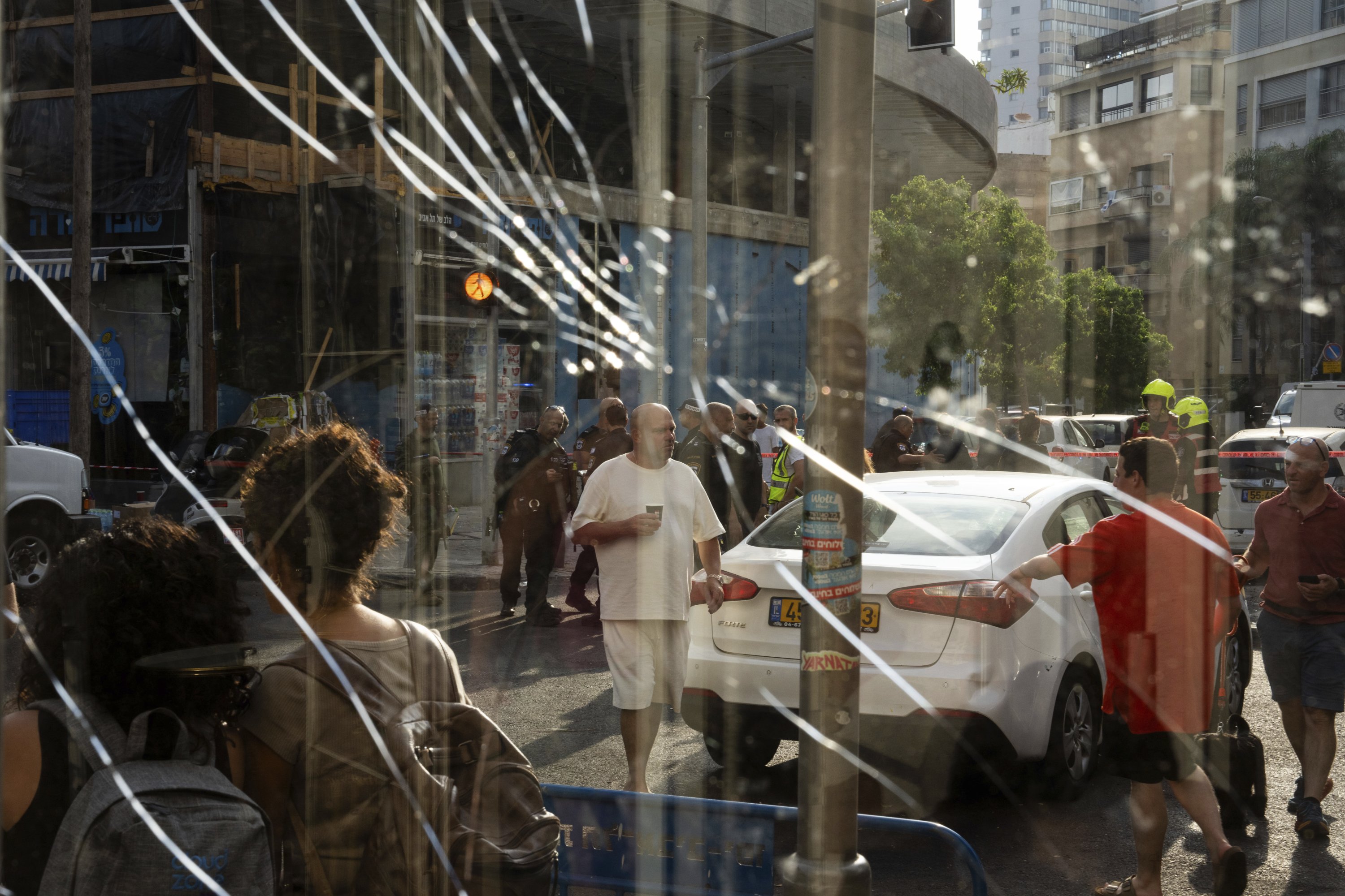 337604 People are seen through a broken window next to the scene of an explosive drone attack, Tel Aviv, Israel, July 19, 2024. (AP Photo)