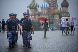 A group of Rosgvardia (National Guard) servicemen walk under the rain through Red Square in Moscow, Russia, July 22, 2024. (AP Photo)