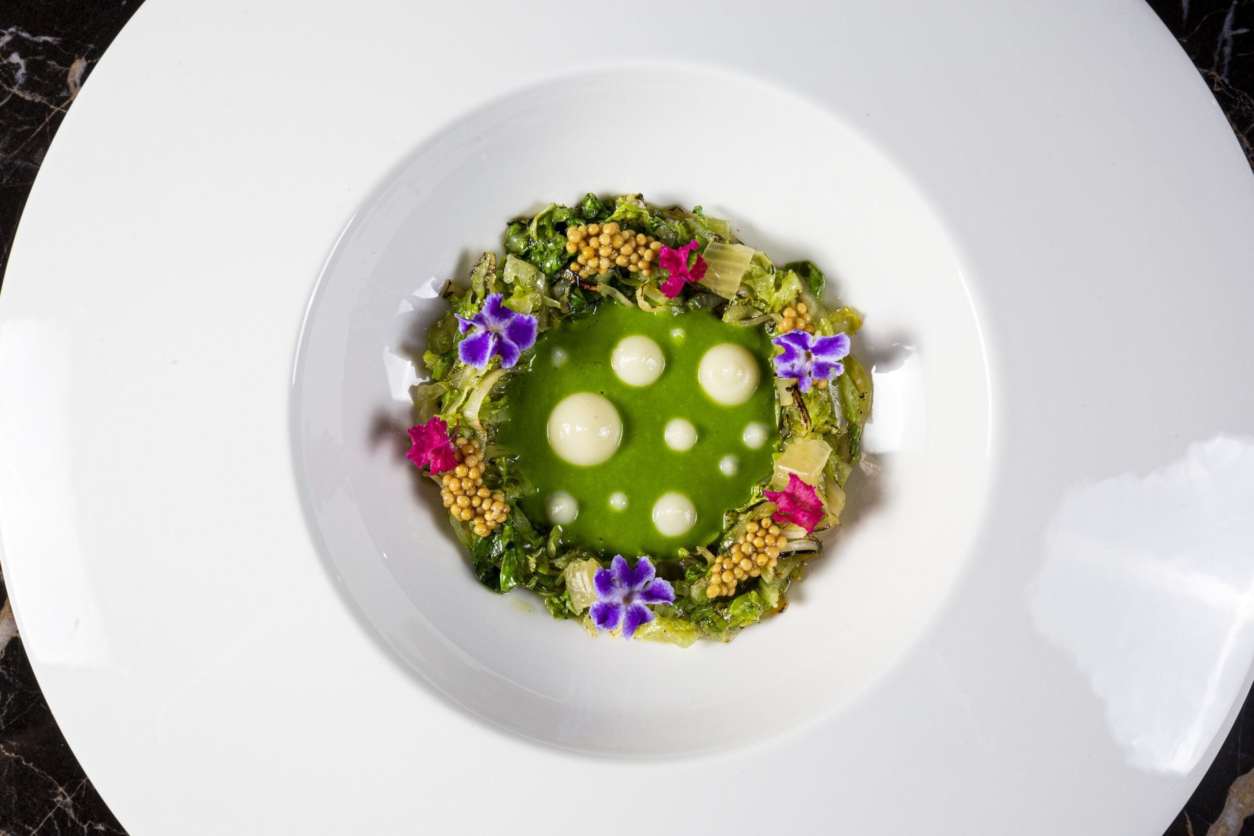 340731 A flower-decorated dish presentation at Il Mirto restaurant, Ischia, Italy, Aug 1, 2024. (Photo by İlker Topdemir)