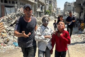 A Palestinian man rescues children injured in an Israeli strike in Khan Younis, southern Gaza Strip, Palestine, Aug. 27, 2024. (Reuters Photo)