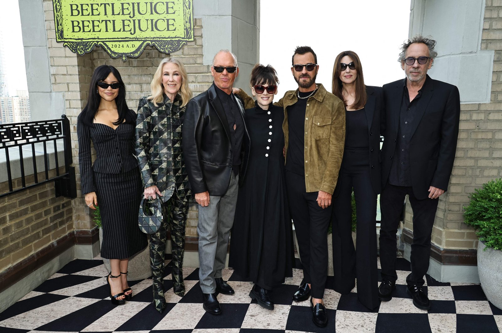 (L-R) Jenna Ortega, Catherine O'Hara, Michael Keaton, Winona Ryder, Justin Theroux, Monica Bellucci and Tim Burton attend the "Beetlejuice Beetlejuice" New York photo call at JW Marriott Essex House, New York City, New York, U.S., Aug. 17, 2024. (AFP Photo)