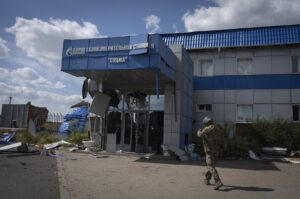 A Ukrainian soldier approaches a gas metering station of Russian energy giant Gazprom in Sudzha, Kursk region, Russia, Aug. 16, 2024. (AP Photo)