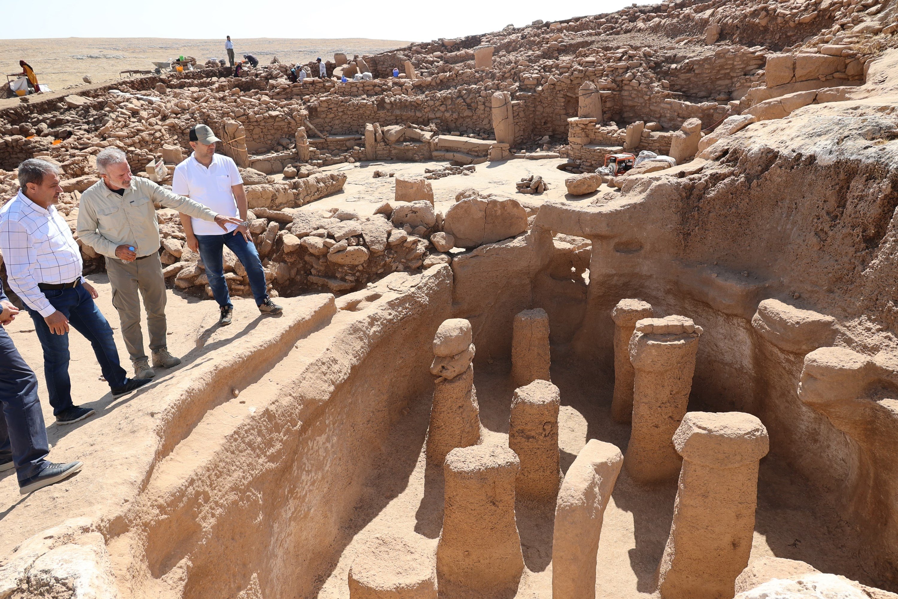 343879 Experts and officials observe the excavation site at the Neolithic site Karahantepe, Şanlıurfa, Türkiye, Aug. 29, 2024. (DHA Photo)
