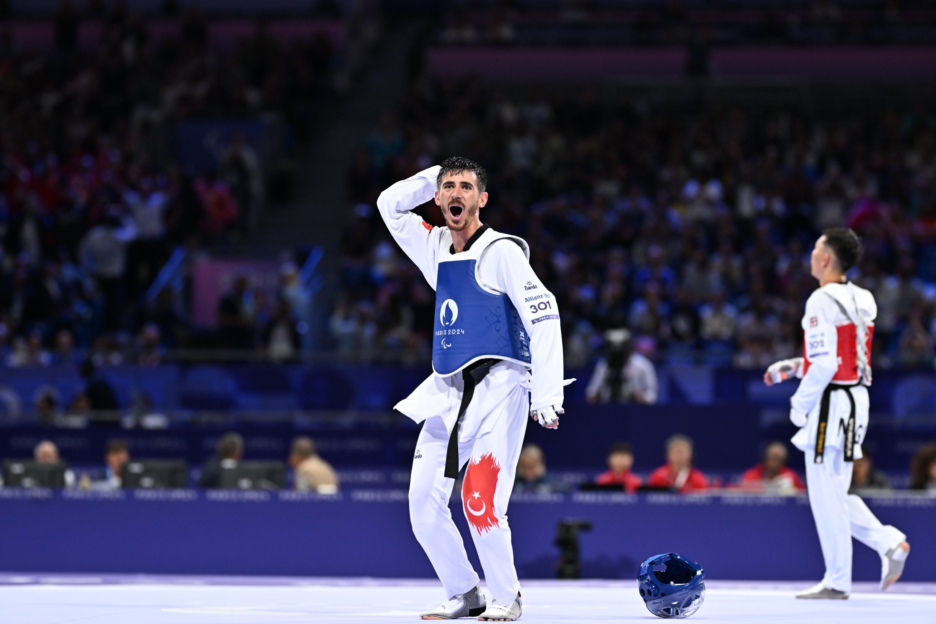 344036 Turkish athlete Mahmut Bozteke (L) celebrates after beating Mongolia's Bolor-Erdene Ganbat at the Grand Palais in the men's taekwondo K44 63 kg. final, Paris, France, Aug. 31, 2024. (AA Photo)