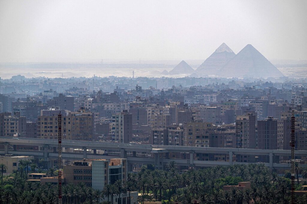 The pyramids appear behind the skyline of Cairo, Egypt, Aug. 25, 2024. (AFP Photo)