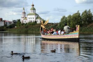 Tourists ride in an ornate wooden boat along the Kamenka River in the town of Suzdal, northeast of Moscow, Russia, Aug. 24, 2024. (AFP Photo)