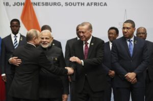 President Recep Tayyip Erdoğan shakes hands with Russian President Vladimir Putin before they pose for a group picture at a BRICS meeting in Johannesburg, South Africa, July 27, 2018. (AP Photo)