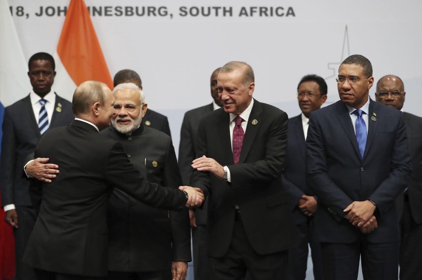 President Recep Tayyip Erdoğan shakes hands with Russian President Vladimir Putin before they pose for a group picture at a BRICS meeting in Johannesburg, South Africa, July 27, 2018. (AP Photo)