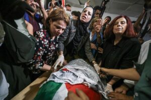 Palestinians and international activists mourn by the body of slain Turkish American activist Aysenur Ezgi Eygi at the Al-Rafidia Hospital morgue in Nablus, the occupied West Bank, Palestine, Sept. 8, 2024. (AFP Photo)