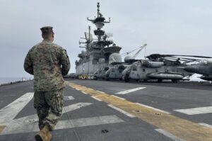 A marine walks on the deck of the amphibious assault ship USS Bataan that is docked at Larnaca port, Greek Cypriot administration, Feb. 13, 2024. (AP Photo)