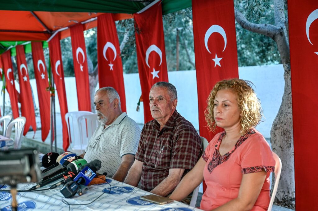 Mehmet Suat Eygi (C), father of Turkish American activist Ayşenur Ezgi Eygi, who was shot dead by Israel in the West Bank, sits next to her uncle Yılmaz Eygi (L), speaks to media near the house of her grandfather, Didim, western Aydın province, Türkiye, Sept.12, 2024. (AFP Photo)