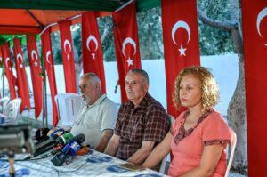 Mehmet Suat Eygi (C), father of Turkish American activist Ayşenur Ezgi Eygi, who was shot dead by Israel in the West Bank, sits next to her uncle Yılmaz Eygi (L), speaks to media near the house of her grandfather, Didim, western Aydın province, Türkiye, Sept.12, 2024. (AFP Photo)
