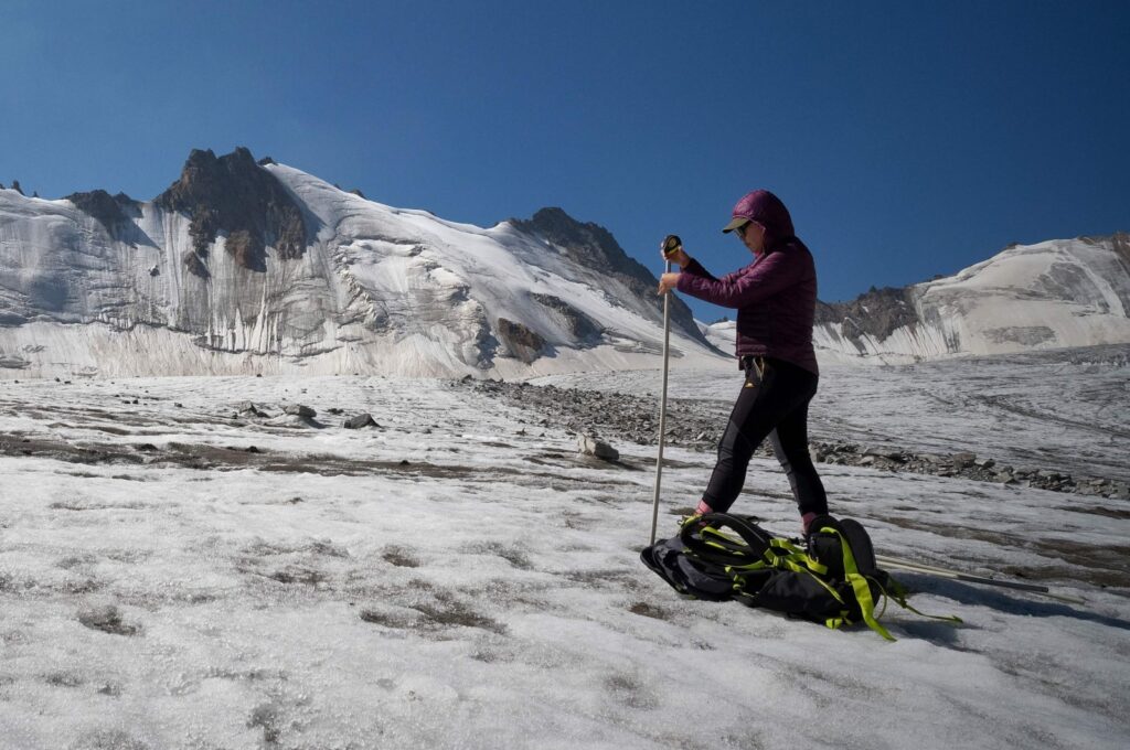 Glaciologist Gulbara Omorova takes measurements of a glacier using an ablation stake in the Tian Shan mountain range, Tian Shan, Kyrgyzstan, July 8, 2024. (AFP Photo)