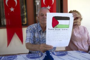 Mehmet Suat Eygi, father of Ayşenur Ezgi Eygi, who was killed by Israel in the West Bank, holds up an anonymous letter addressed to his daughter during an interview at his family home, in the Aegean province of Aydın, Türkiye, Sept. 16, 2024. (AA Photo)