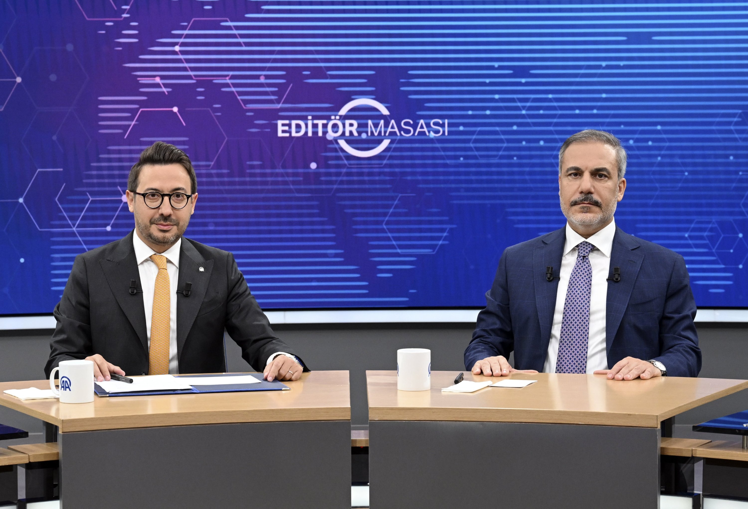 347763 Foreign Minister Hakan Fidan (R) and Anadolu Agency (AA) President and Chief Executive Officer Serdar Karagöz pose for a photo during the AA Editor's Desk interview, Ankara, Türkiye, Sept. 19, 2024. (AA Photo)