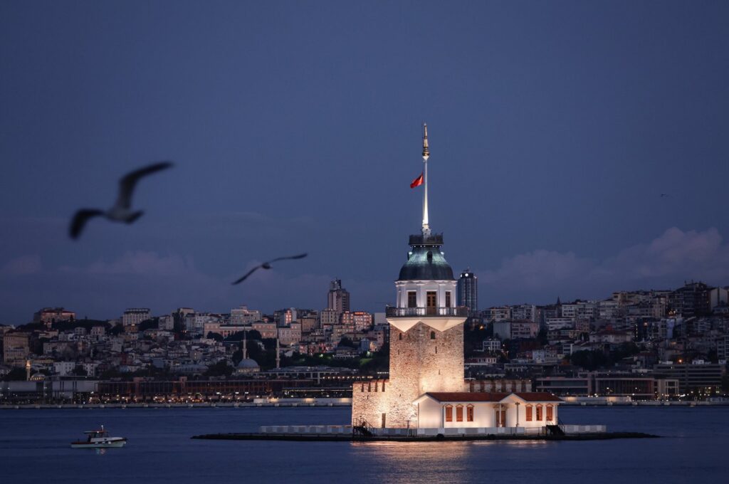 Seagulls fly around Maiden's Tower on the Bosporus during sunrise in Istanbul, Türkiye, Sept. 18, 2024. (EPA Photo)