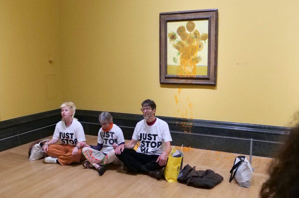 A handout picture from the Just Stop Oil climate campaign group shows three activists sitting on the floor under Vincent Van Gogh's "Sunflowers" in central London, U.K., Sept. 27, 2024. (AFP Photo)