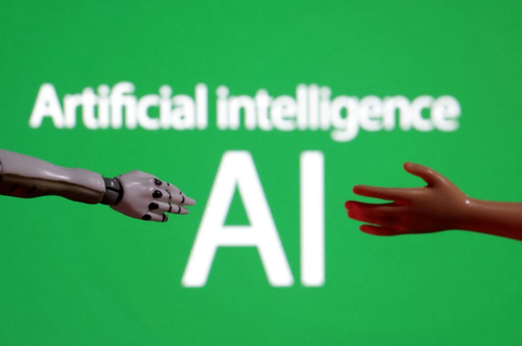 Words reading "Artificial intelligence AI," and miniatures of robot and toy hands are pictured in this illustration taken on Dec. 14, 2023. (Reuters Photo)