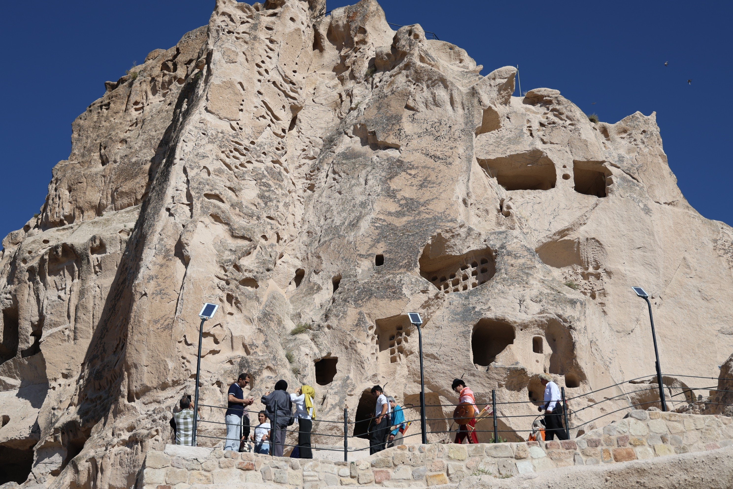 350731 Tourists are photographed close to the caves in the Capadoccia region, central Türkiye, Oct. 2, 2024. (AA Photo)
