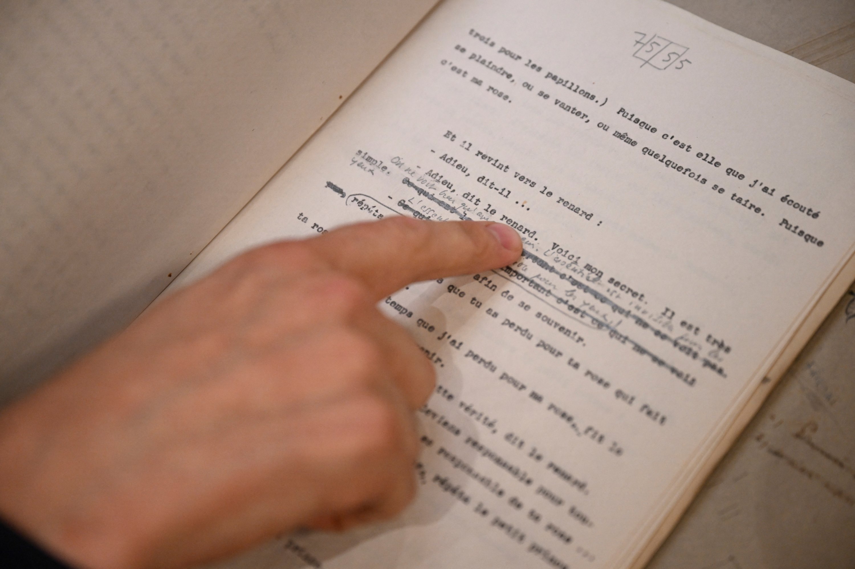 351890 Sammy Jay, Peter Harrington's literature specialist, points to handwritten corrections on a rare carbon typescript of Antoine de Saint-Exupery's