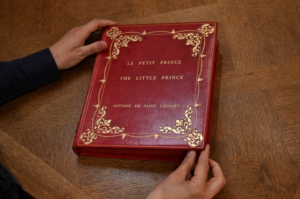 Sammy Jay, Peter Harrington's literature specialist, holds the casing containing a rare carbon typescript of Antoine de Saint-Exupery's "Le Petit Prince," London, U.K., Oct. 15, 2024. (Reuters Photo)