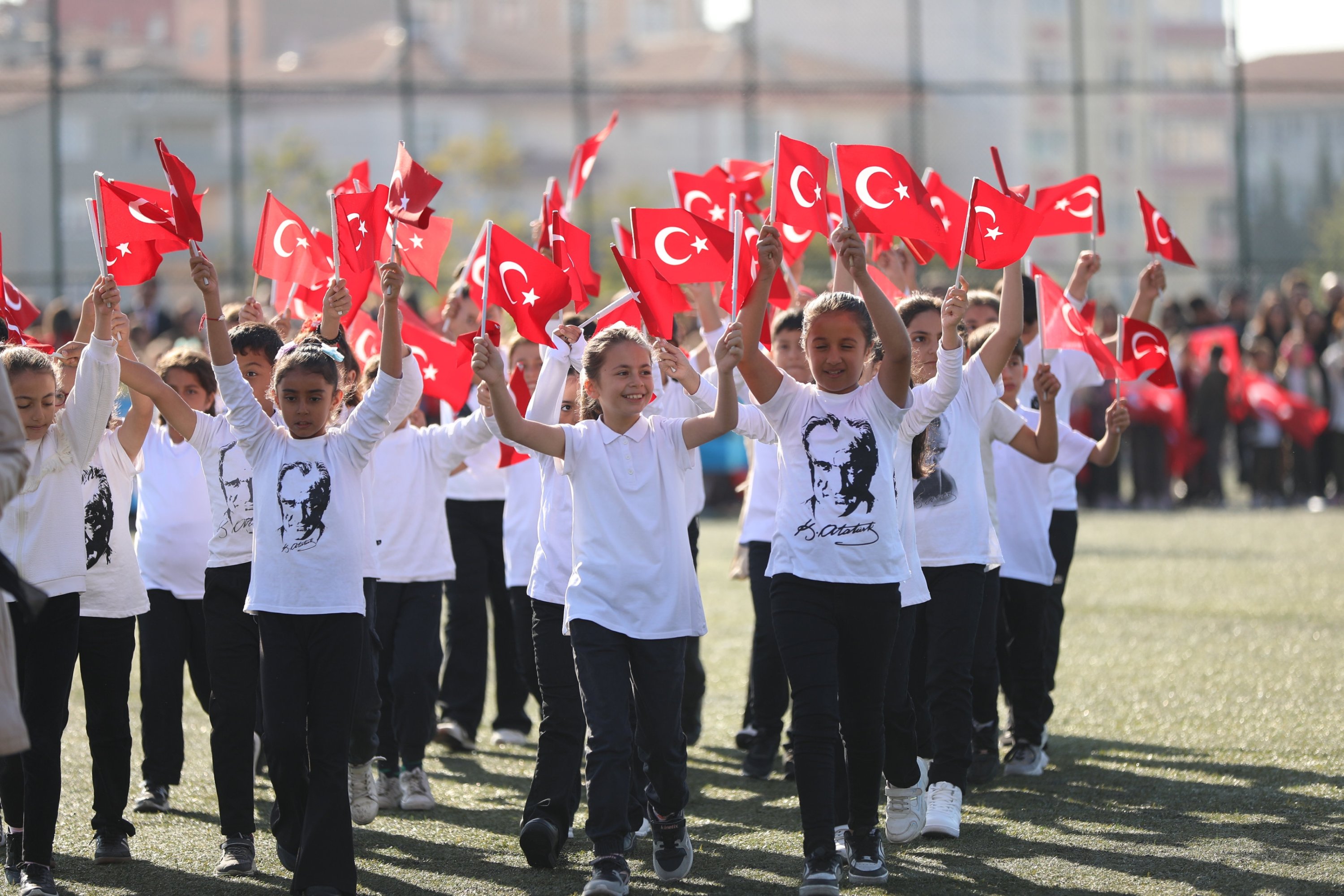 352553 Children wearing T-shirts with the faces of Atatürk wave Turkish flags during a Republic Day celebration, in the Kapaklı district, Tekirdağ, northwestern Türkiye, Oct. 29, 2024. (AA Photo)