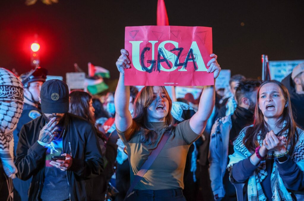 A protester holds up a sign reading "USA" with "Gaza" written on top south of the White House, Washington, DC, Oct. 29, 2024. (AFP Photo)