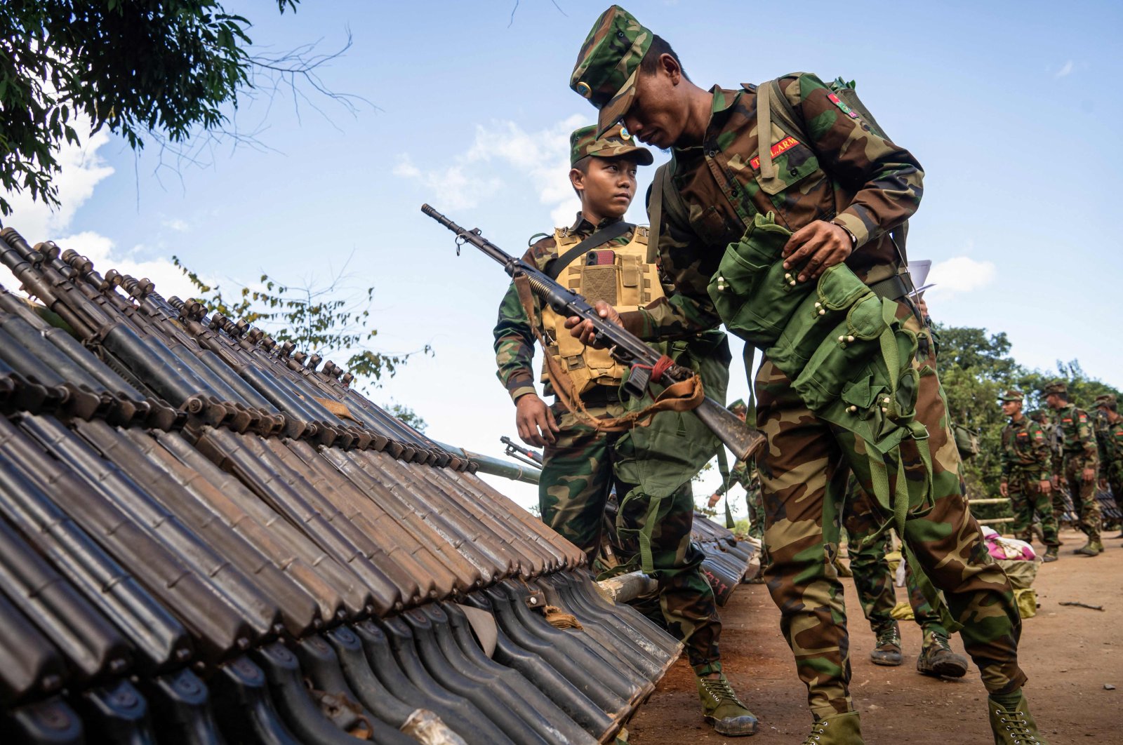 Ta'ang National Liberation Army (TNLA) members receive military equipment at a graduation ceremony after special combat training, near Namhkam, Myanmar, Nov. 9, 2024. (AFP Photo)