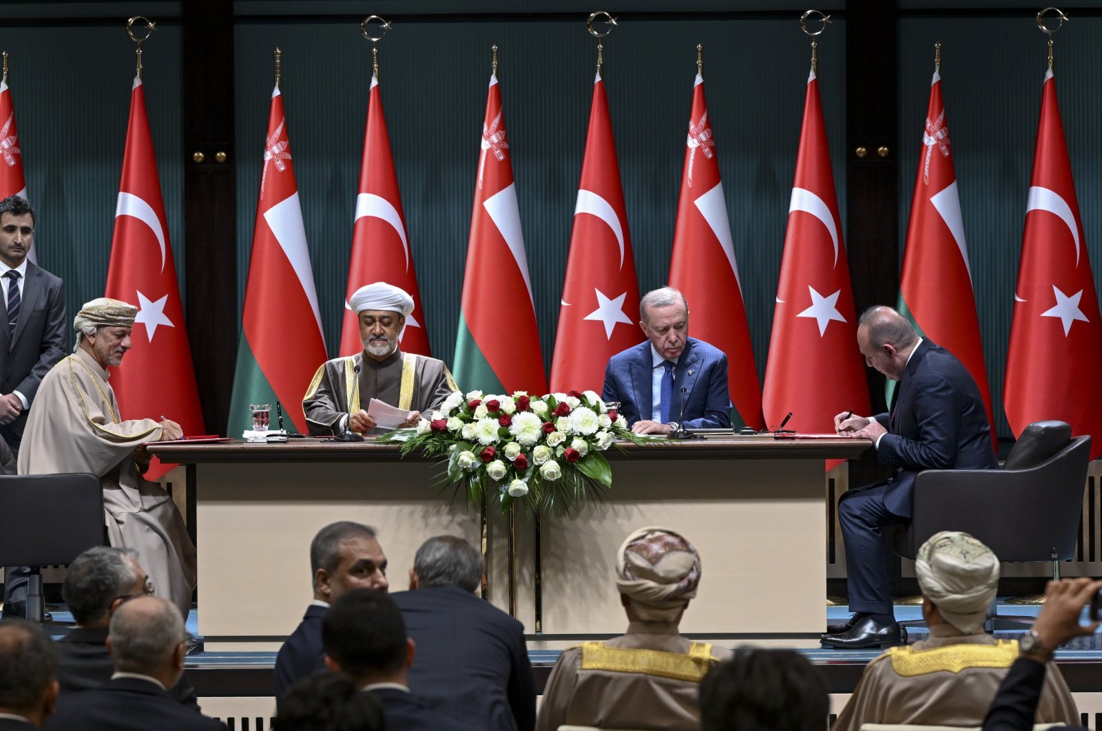 President Recep Tayyip Erdoğan (C-R) and Oman's Sultan Haitham bin Tariq Al Said (C-L) oversee a signing ceremony between OYAK and the Oman Investment Authority, Ankara, Türkiye, Nov. 28, 2024. (AA Photo)