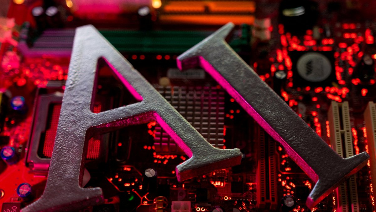 AI (artificial intelligence) letters are placed on a computer motherboard in this illustration taken June 23, 2023. (Reuters Photo)