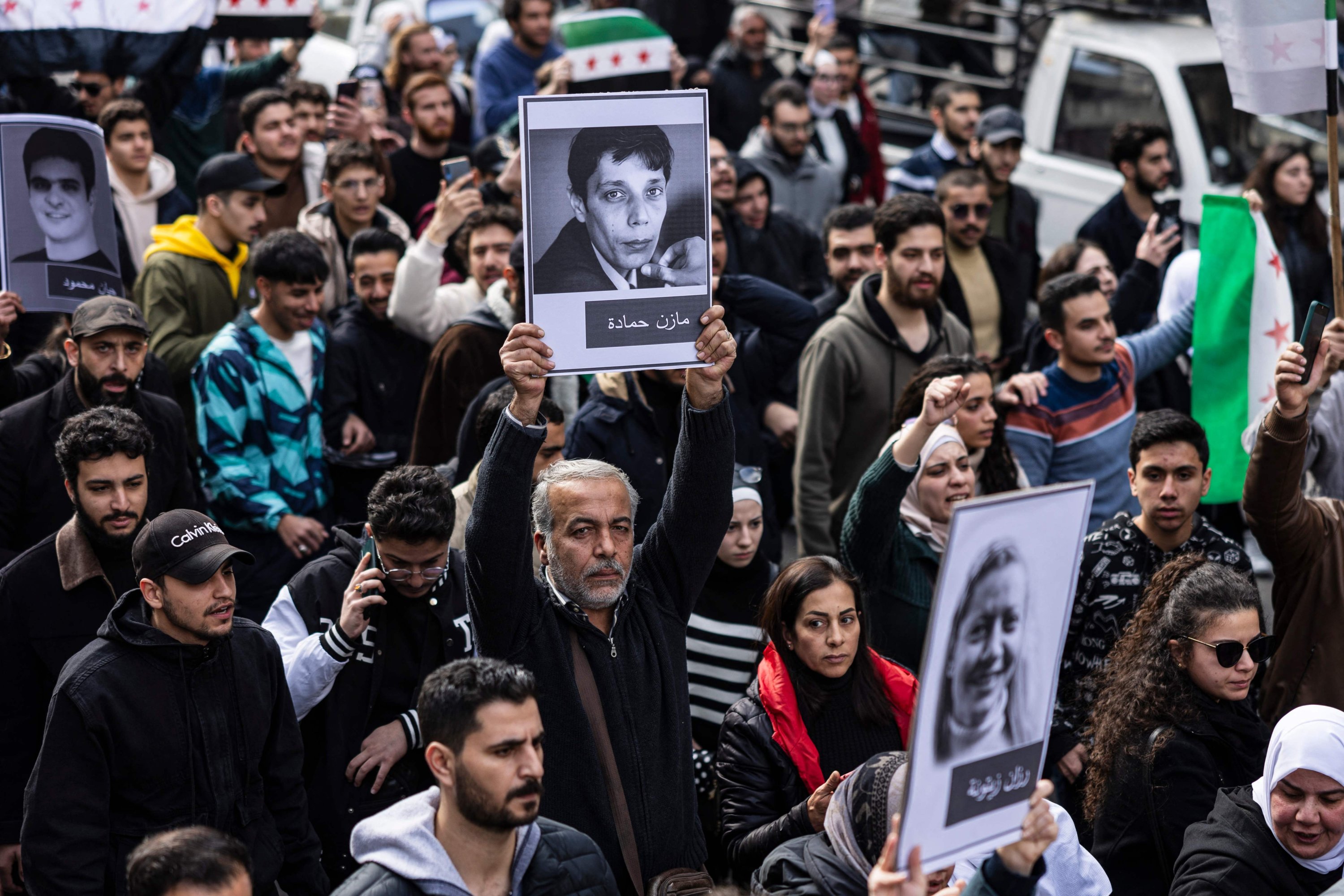 359333 Mourners attend the funeral of Syrian activist Mazen al-Hamada (portrait), whose body was found recently, Damascus, Syria, Dec. 12, 2024. (AFP Photo)