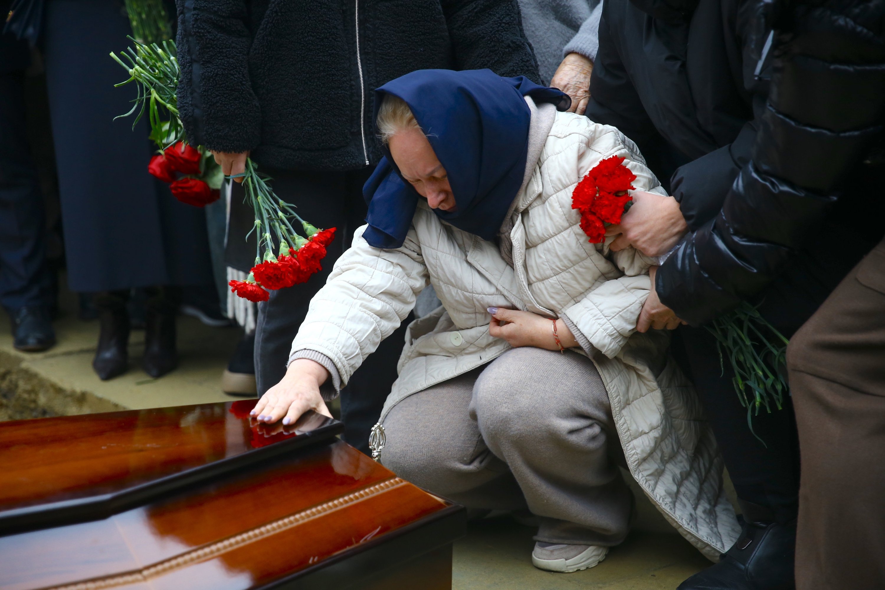 361567 A family member of the Azerbaijan Airlines pilots who died in a crash Wednesday mourns during their burial, Baku, Azerbaijan, Dec. 29, 2024. (AA Photo)