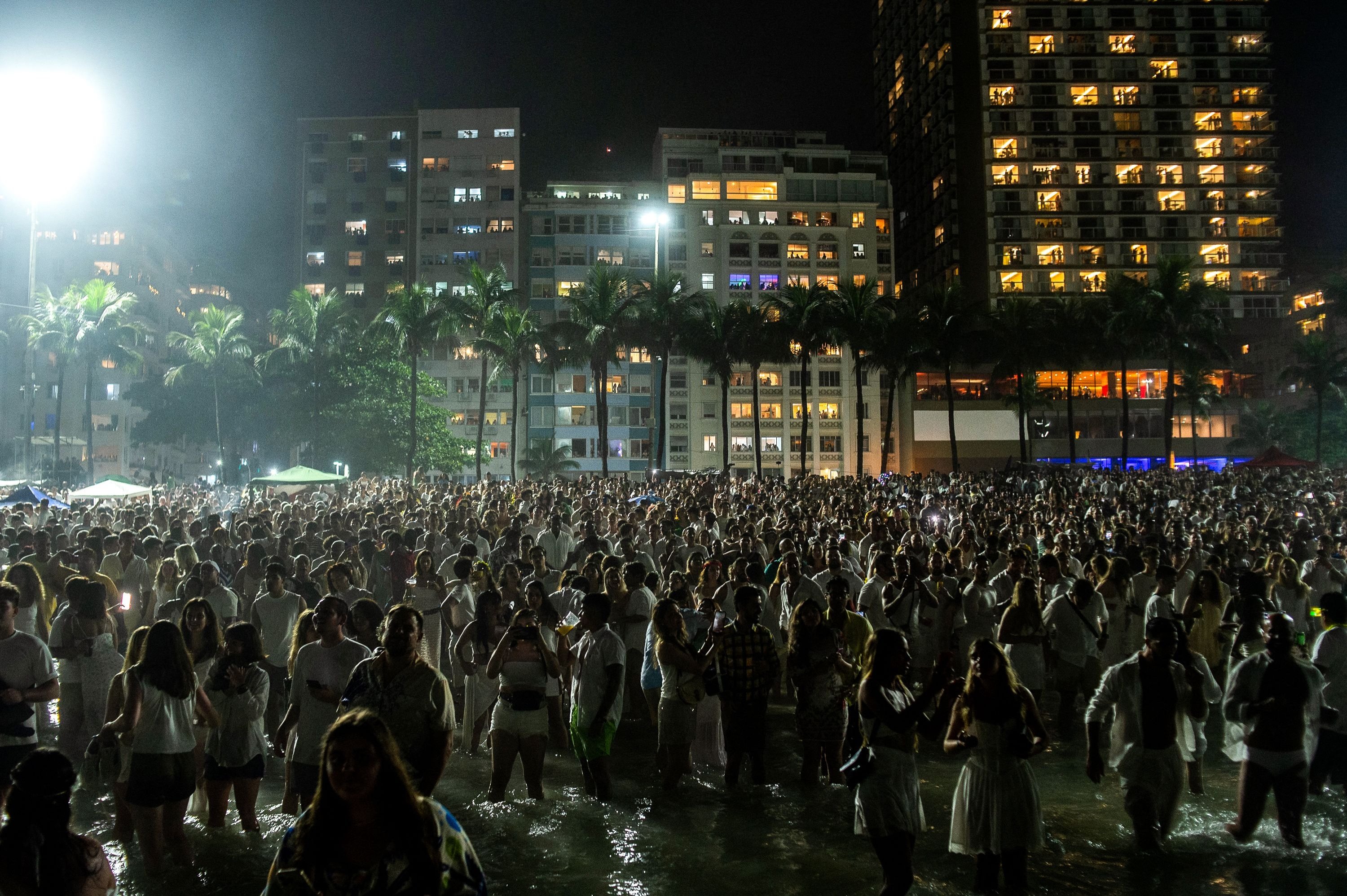 361962 People stand on the beach to watch the traditional New Year's fireworks at Copacabana Beach in Rio de Janeiro, Brazil, Jan. 1, 2025. (AFP Photo)