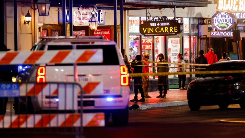 Law enforcement vehicles and people stand near the area near the scene where a vehicle drove into a crowd during New Year's celebrations, in New Orleans, Louisiana, U.S., January 1, 2025. REUTERS/Eduardo Munoz