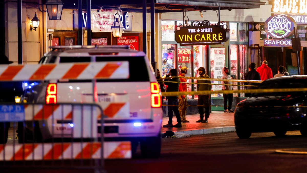Law enforcement vehicles and people stand near the area near the scene where a vehicle drove into a crowd during New Year's celebrations, in New Orleans, Louisiana, U.S., January 1, 2025. REUTERS/Eduardo Munoz