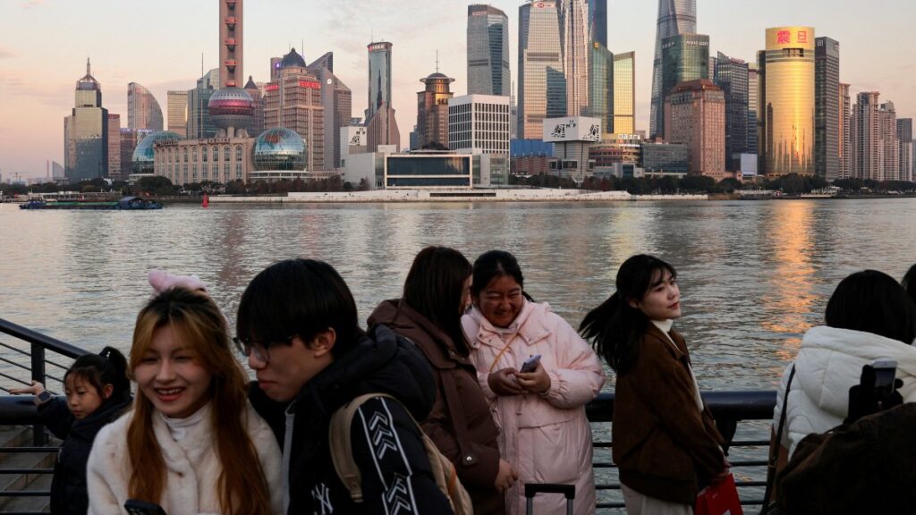 People hang out at The Bund as the financial district of Pudong is seen in the background in Shanghai, China, Jan. 16, 2025. (Reuters Photo)