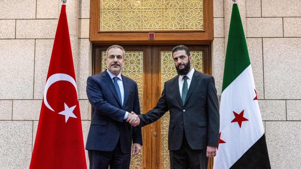 Foreign Minister Hakan Fidan (L) is received by Syria's de-facto leader Ahmed al-Sharaa in Damascus, Syria, Dec. 22, 2024. (AFP Photo)