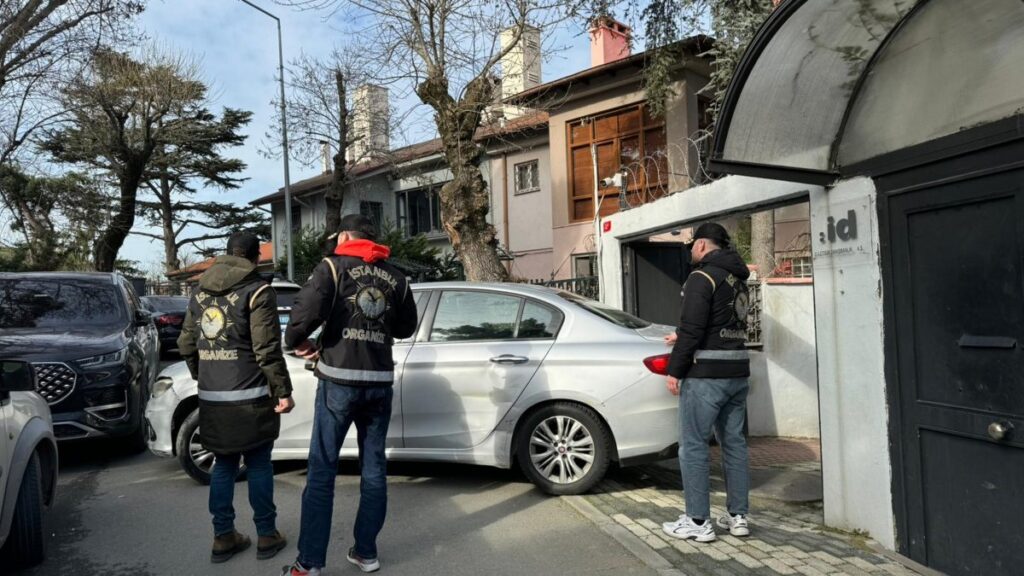 Police officers stand outside Ayşe Barım's home as they search for evidence following her detention, Istanbul, Türkiye, Jan. 24, 2025. (AA Photo)