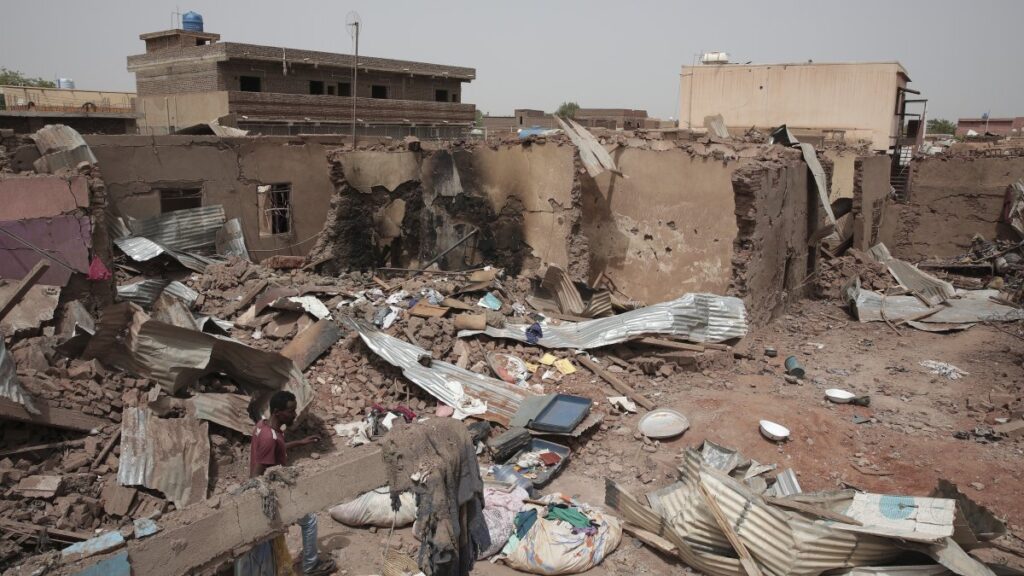 A man walks by a house hit in recent fighting in Khartoum, Sudan, April 25, 2023. (AP Photo)