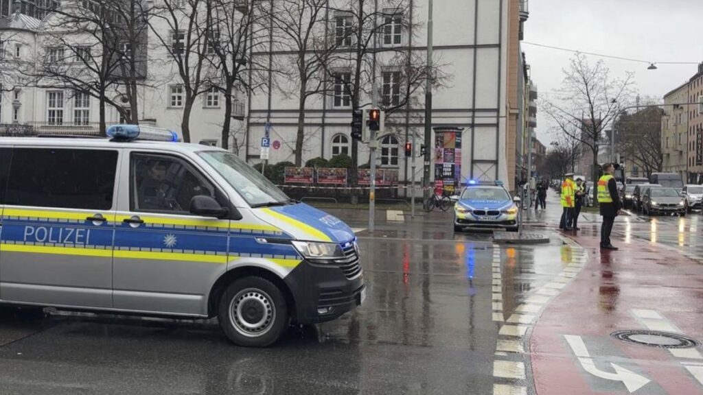 A police car attends the scene of an accident after a driver hit a group of people in Munich, Germany, Thursday Feb. 13, 2025. (Roland Freund/dpa via AP)