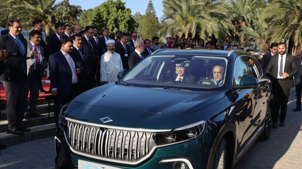 President Recep Tayyip Erdoğan and Pakistani Prime Minister Shahbaz Sharif drive a Togg T10X, Türkiye's domestic electric car, in Islamabad, Pakistan, Feb. 13, 2025. (DHA Photo)