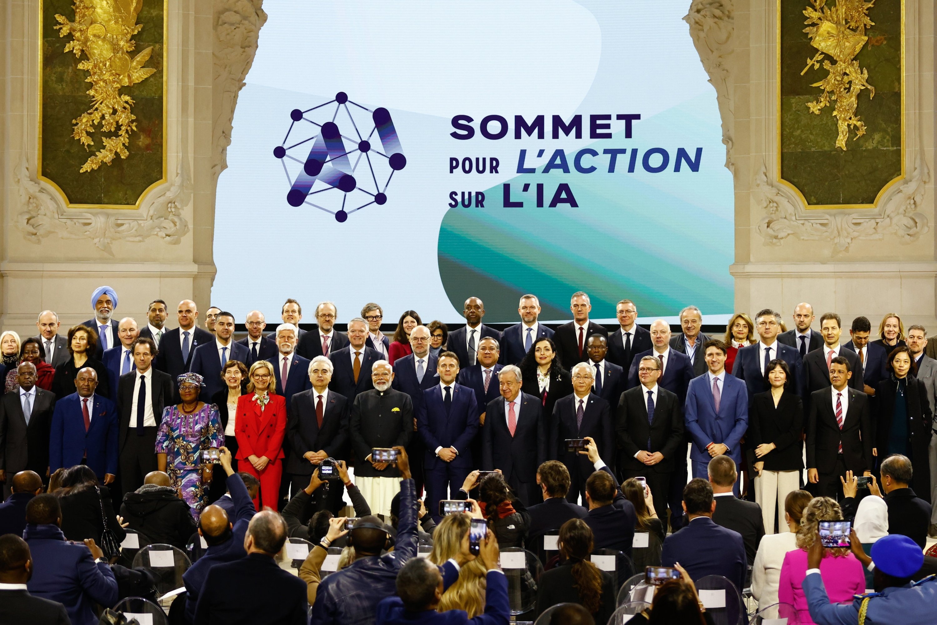368513 French President Emmanuel Macron (C), Indian Prime Minister Narendra Modi (C-L), U.N. Secretary-General Antonio Guterres (C-R) and other leaders pose for a family photo with participants at the end of a plenary session during the Artificial Intelligence Action Summit, Paris, France, Feb. 11, 2025. (EPA Photo)