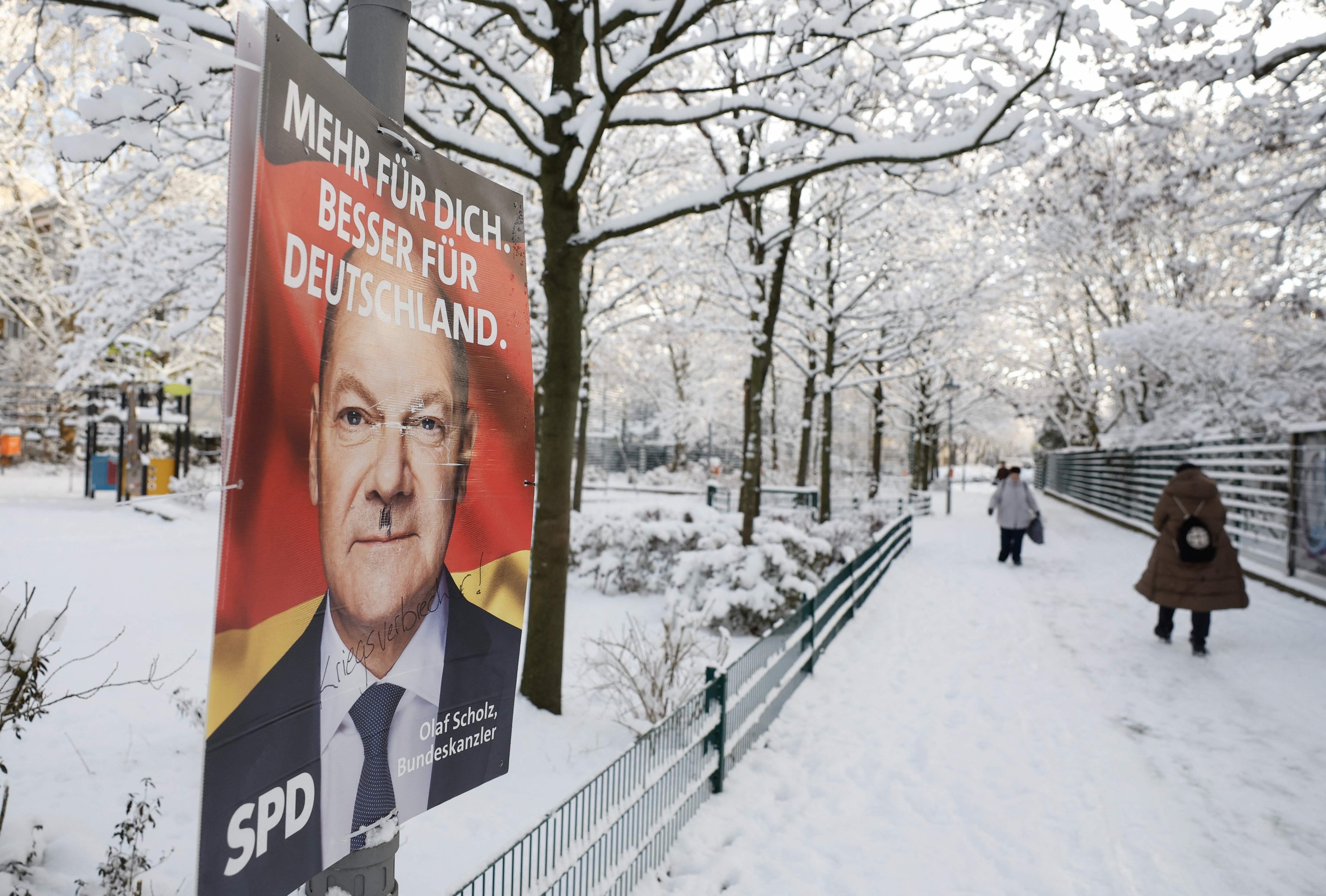 368844 People walk past an election campaign ad poster for the Social Democratic Party (SPD) featuring German Chancellor Olaf Scholz, the SPD's main candidate, Berlin, Germany, Feb. 14, 2025 (AFP Photo)